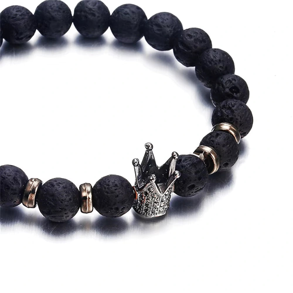 Black beaded bracelet with a crown-shaped charm on a white background