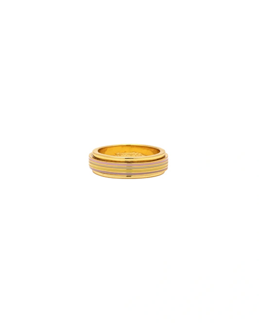 Gold ring with a striped pattern on a white background