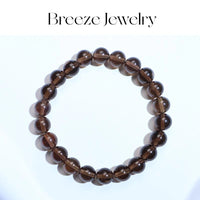 Brown beaded bracelet on a white background with 'Breeze Jewelry' branding.