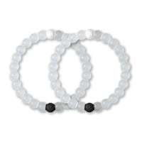 Two white beaded bracelets with black beads on a white background