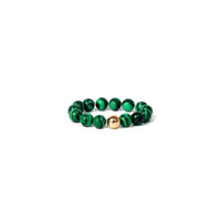 Green beaded ring with a gold accent on a white background