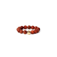 ring with red beads and a gold bead on a white background
