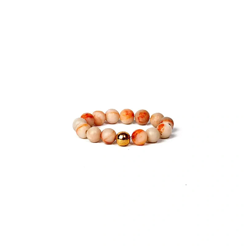 Beaded ring with multicolored beads on a white background