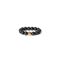 Black beaded ring with a gold accent on a white background