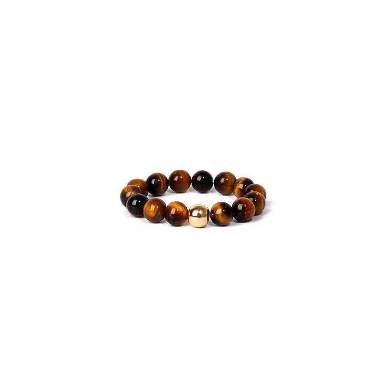 Beaded ring with brown and gold beads on a white background
