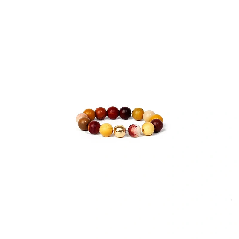 Multicolored beaded ring on a white background